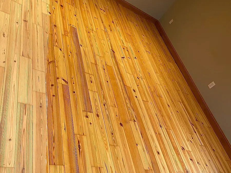 Hardwood floor with a natural finish showing knots and grain